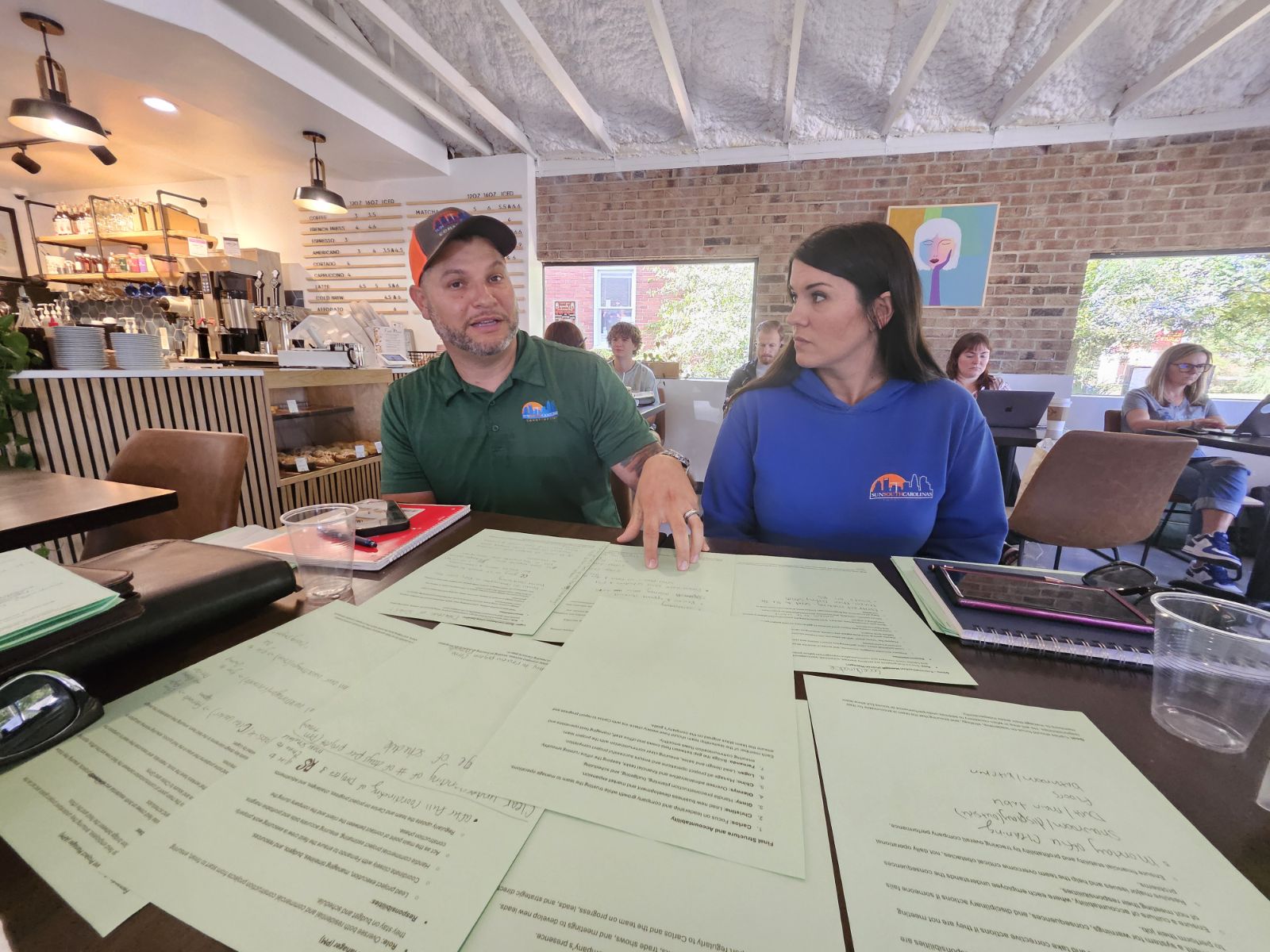 Two small-business owners reviewing documents together
