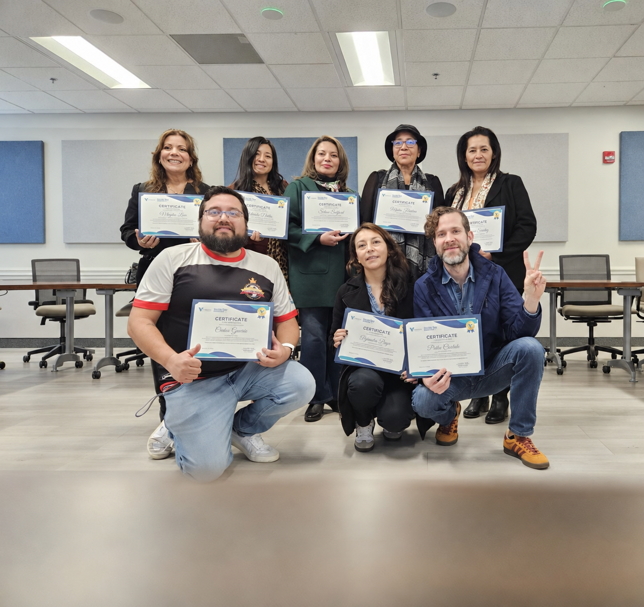 Eight participants and program partners holding certificates after completing the United Way Nonprofit 101 Spanish Cohort